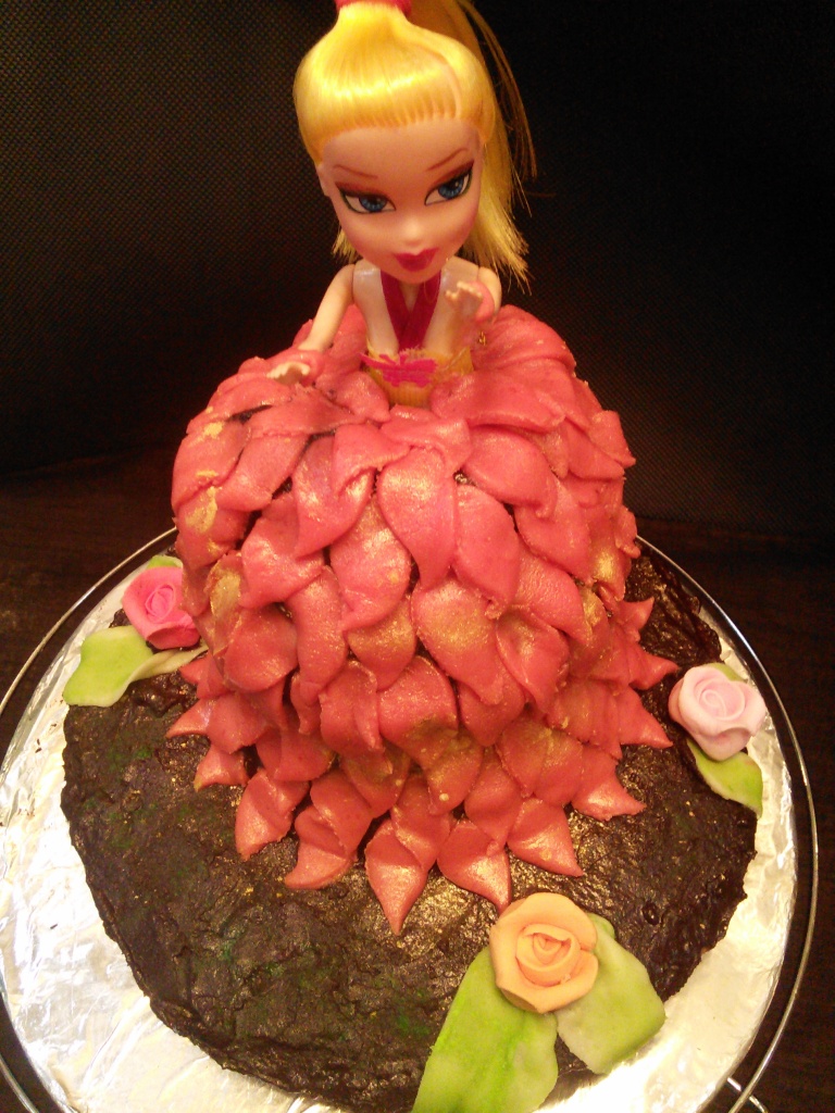 Vanilla Cake covered in chocolate ganache and molded to look like a princess...