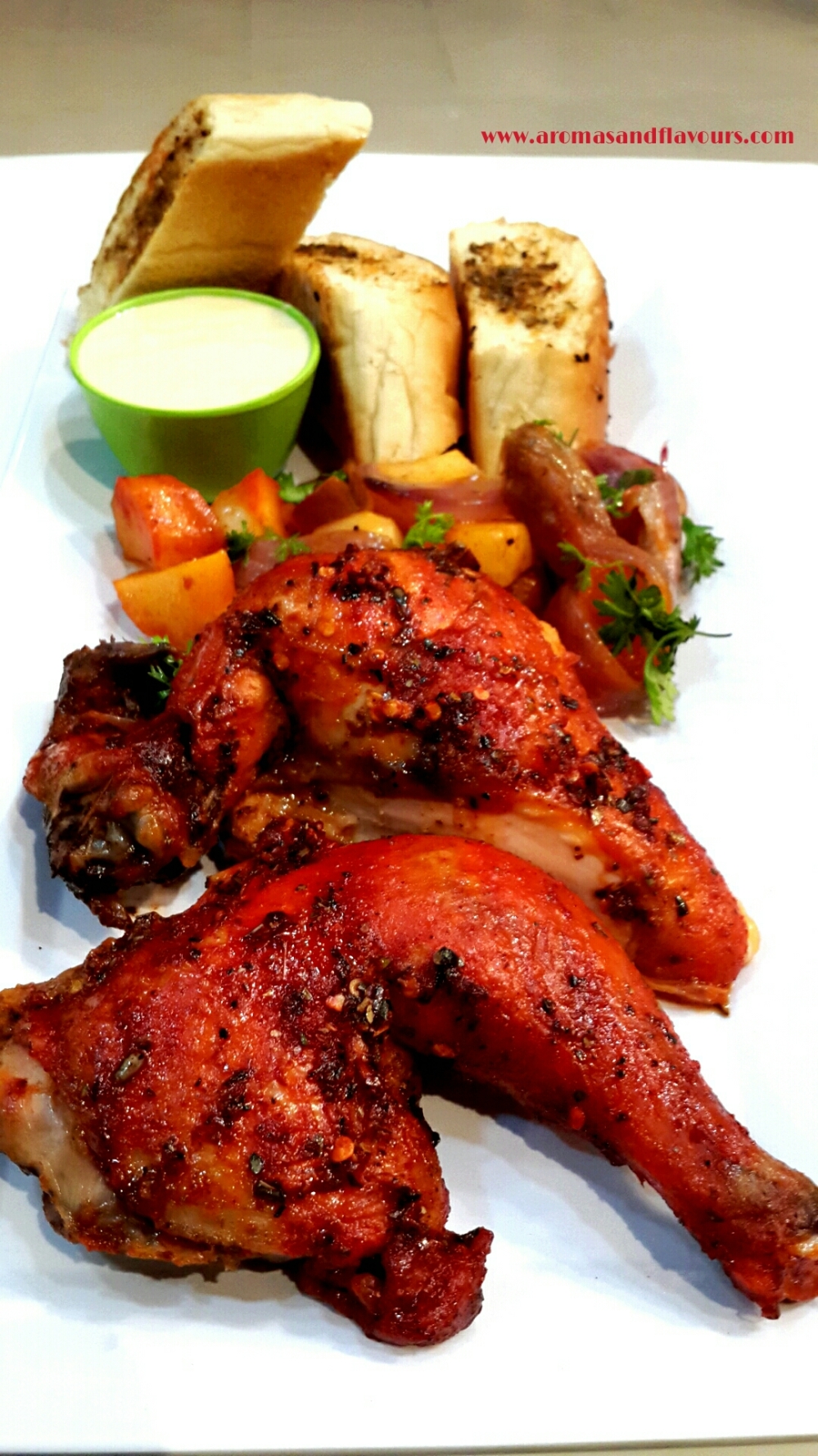 Peri Peri chicken with Musk Melon dip, roasted potatoes, caramelized onions and garlic bread